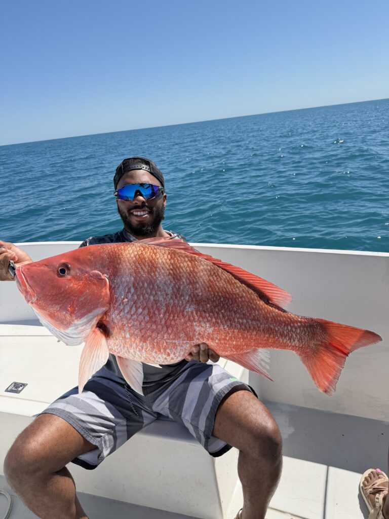 Beast Coast Fishing Charters Man holds large red snapper