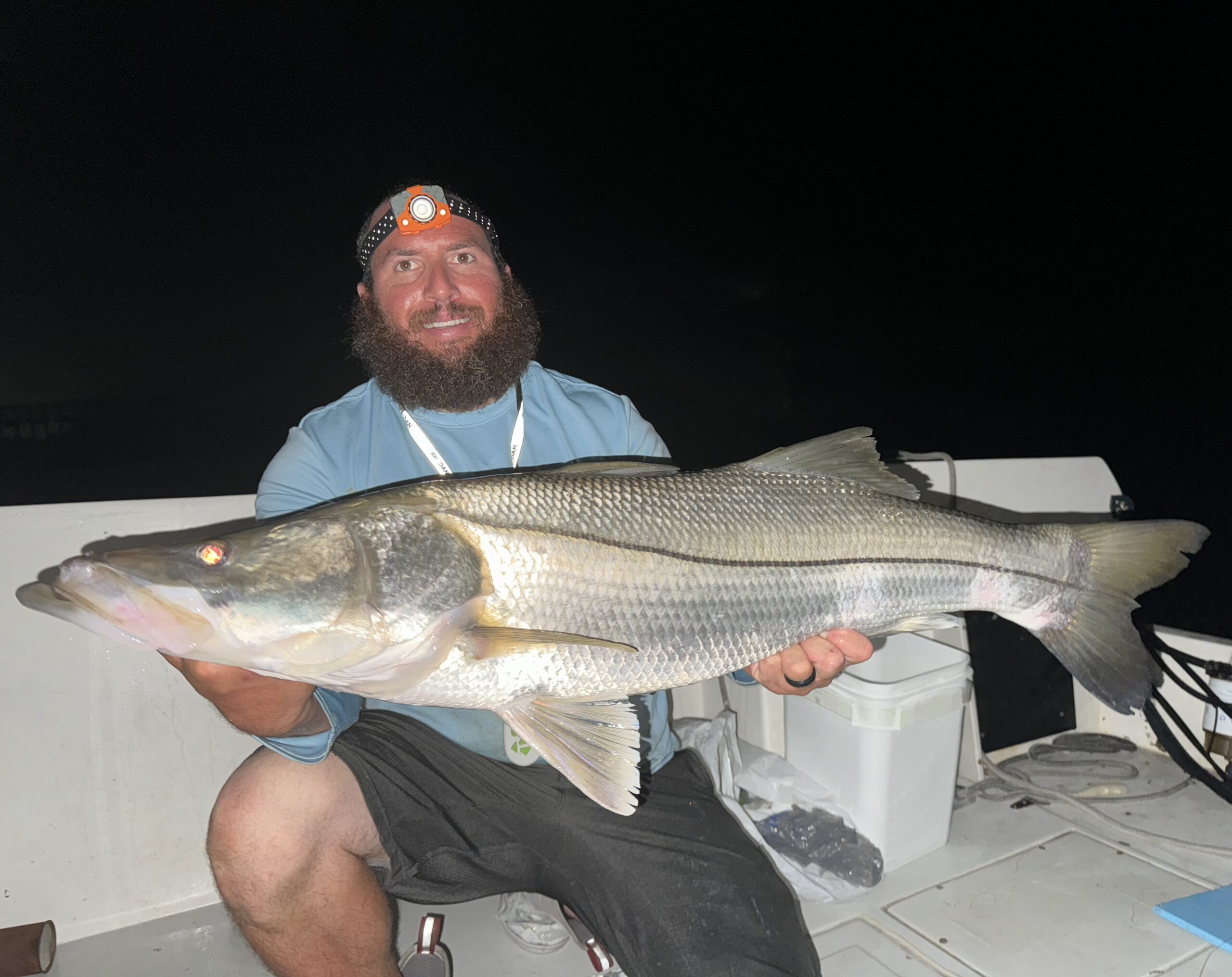 Beast Coast Fishing Charters Man holding large snook at night