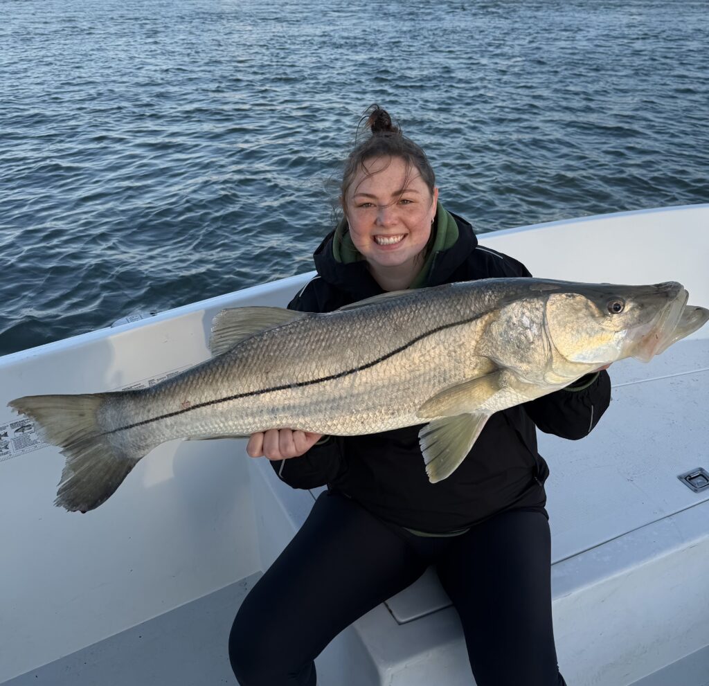 Beast Coast Fishing Charters Woman holding large snook near New Smyrna Beach