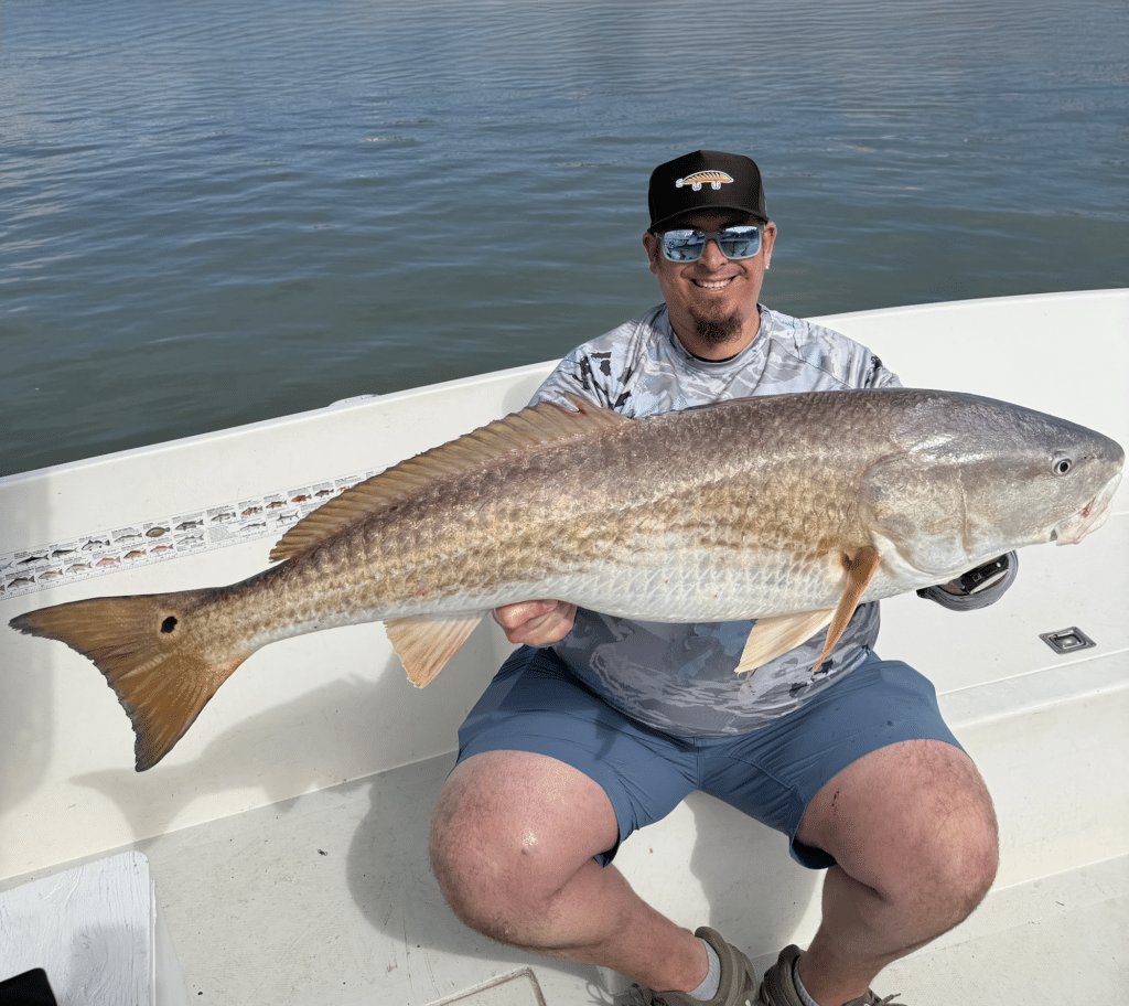Beast Coast Fishing Charters Man with large redfish in New Smyrna Beach